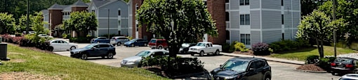 a parking lot with several apartment buildings in the background