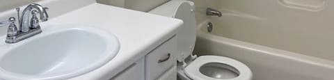 a bathroom with a sink toilet and shower