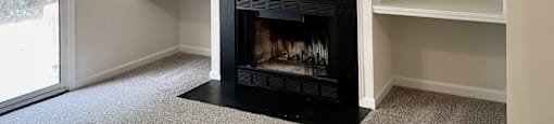 a living room with a fireplace and built in shelving