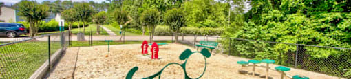 a park with a playground and trees in the background