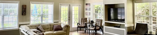 a living room filled with furniture and a large window