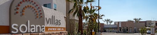 A sign for Solana Villas Apartment Homes is shown in front of a building.