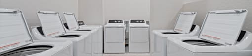 A row of washing machines in a laundromat.