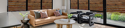 A modern living room with a sofa, chairs, and a coffee table.