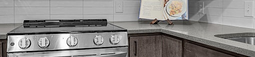 A modern kitchen with a stainless steel oven and microwave.