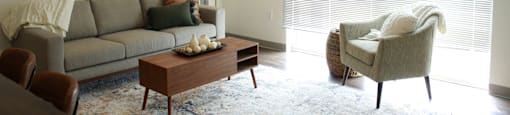 a living room with a couch chair and coffee table