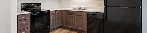 Fully-Equipped Kitchen with Black Appliances at Alo Apartments in Buffalo MN