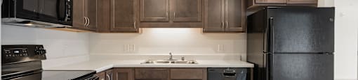 Kitchen with Dark Cabinetry at Alo Apartments in Buffalo MN