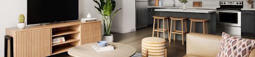 a living room and kitchen with a couch and a table