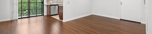 A room with wooden floors and a ceiling fan.
