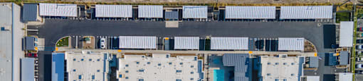 a bird's eye view of a building complex with blue and white roofs at Loma Villas Apartments, California