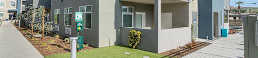 a picture of a building with a green lawn and blue sky in the background at Loma Villas Apartments, San Bernardino California