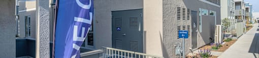 a building with a blue flag in front of it at Loma Villas Apartments, California