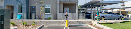 a parking area with EV charging station at Loma Villas Apartments, San Bernardino, CA