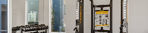 a home gym with a variety of exercise equipment at Loma Villas Apartments, San Bernardino, CA