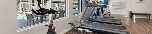 the gym with a stationary bike and treadmills at Loma Villas Apartments, San Bernardino California