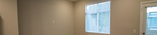 a bedroom with hardwood floors and a window at Loma Villas Apartments, San Bernardino, 92408
