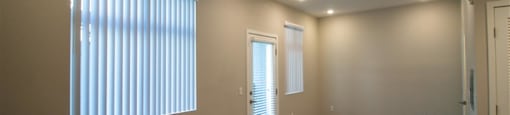 an empty room with a radiator and a large window at Loma Villas Apartments, California