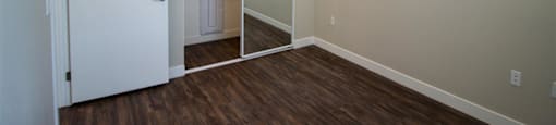 a bedroom with a closet and a door to a bathroom at Loma Villas Apartments, San Bernardino