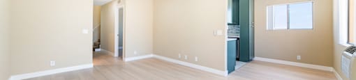 Open concept living area with light wood floors at Joro Properties Apartments, Hollywood