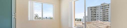 Bright bedroom with ceiling fan and city views at Joro Properties Apartments, California, 90046