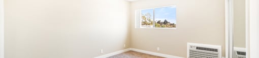 Spacious carpeted bedroom with natural light at Joro Properties Apartments, Hollywood, 90046