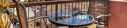 Balcony with glass table and downtown skyline view at Joro Properties Apartments, Hollywood, CA 90046
