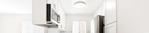 Modern galley kitchen with stainless steel appliances at Joro Properties Apartments, California, 90046