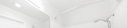 Modern bathroom with white vanity and tub shower combo at Joro Properties Apartments, Hollywood