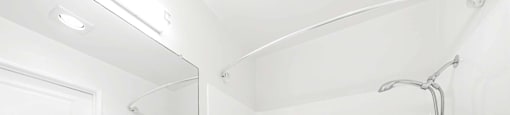 Modern bathroom with white vanity and tub shower combo at Joro Properties Apartments, Hollywood, CA