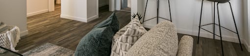 an open living room and kitchen with a bar and stools at AYA ABQ, Albuquerque, NM, 87109