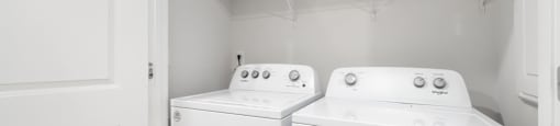 a washer and dryer in a white room with a white door at Ashford Townes Apartments, Fuquay-Varina, NC, 27526