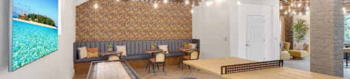 A room with a shiny wooden floor and a long table with a shiny wooden top.