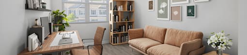 a living room with a couch and a desk at Ashford Townes Apartments, North Carolina
