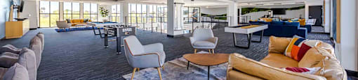 A spacious living room with a variety of seating options and a large window.