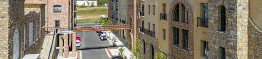 a view of a city street with buildings and a bridge