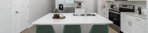 a kitchen with white cabinets and a white counter top at Ashford Townes Apartments, North Carolina, 27526