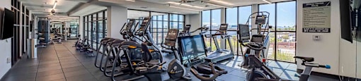 A gym with treadmills and exercise bikes.