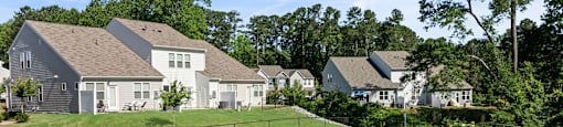 a fenced in dog park with houses in the background at Ashford Townes Apartments, Fuquay-Varina, NC, 27526
