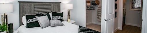 a bedroom with a large bed and a door to a bathroom