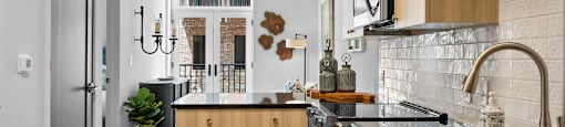 a kitchen with black countertops and wood cabinets