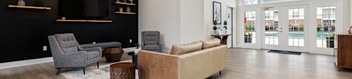 clubhouse with a sitting area, a TV and large windows opening to the pool