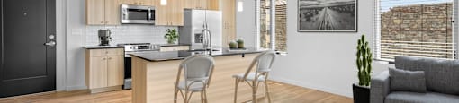 a kitchen and living room with wood floors and white walls