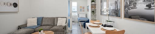a living room with a table and chairs and a couch