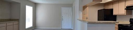 Unfurnished model home living room with view of kitchen