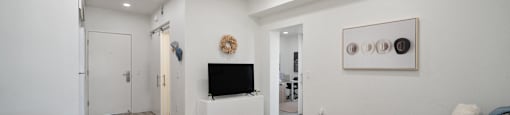 a living room with a couch and a table and a television