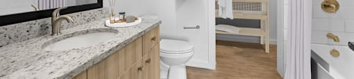 a bathroom with a toilet sink and bathtub in a 555 waverly unit