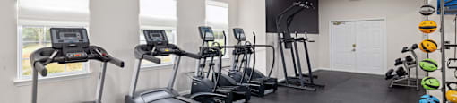 the fitness enter with treadmills and a TV