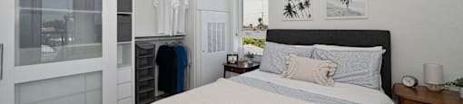 a bedroom with a large bed and a closet