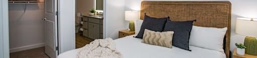 a bedroom with a large bed and a bathroom
